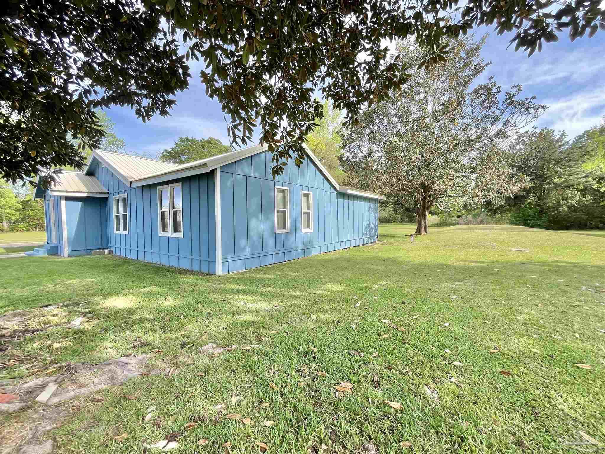102 W Avenue Atmore, AL 36502 - Photo 22 of 25 a view of a house with a backyard