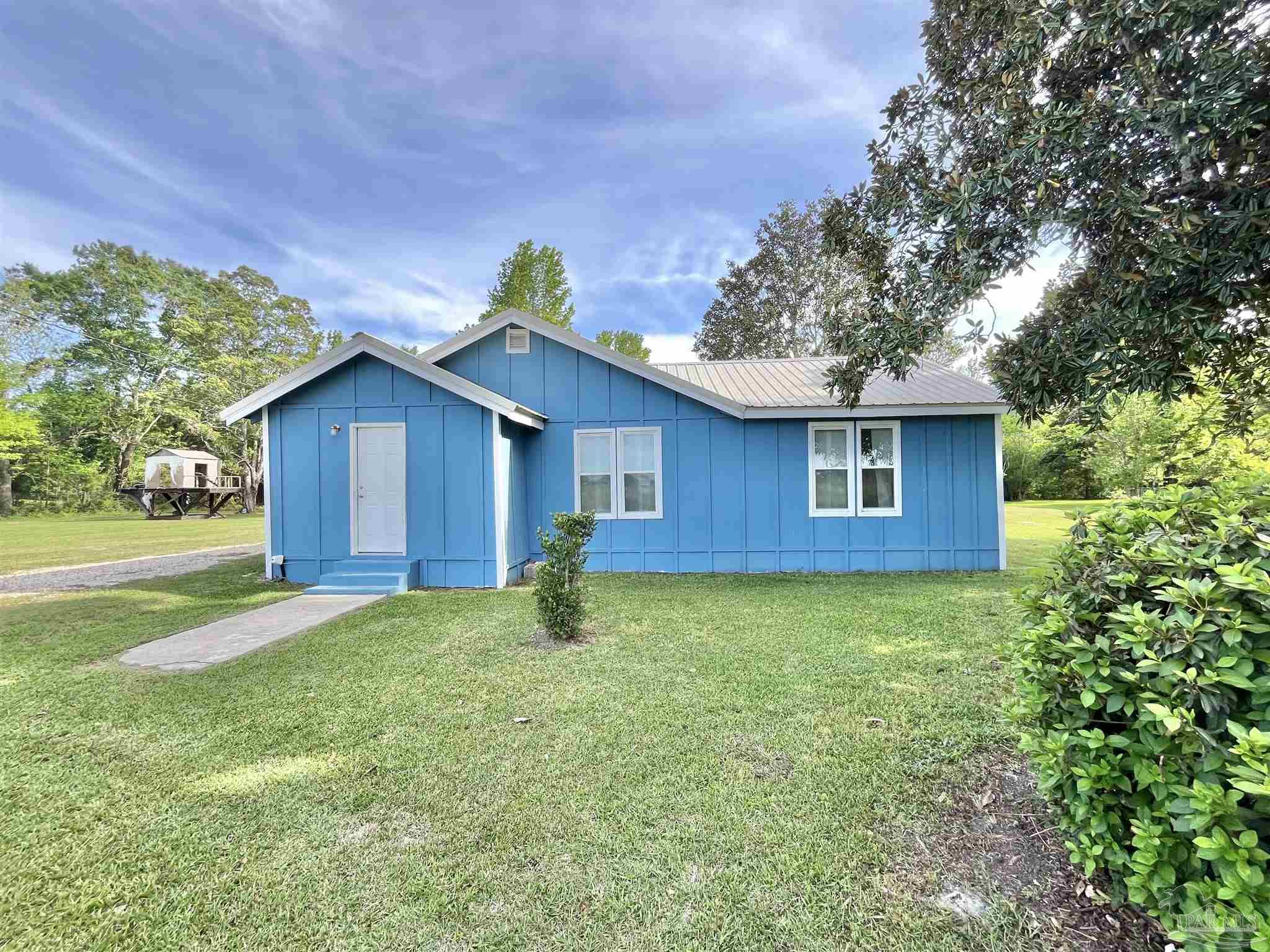 102 W Avenue Atmore, AL 36502 - Photo 3 of 25 a house view with a garden space