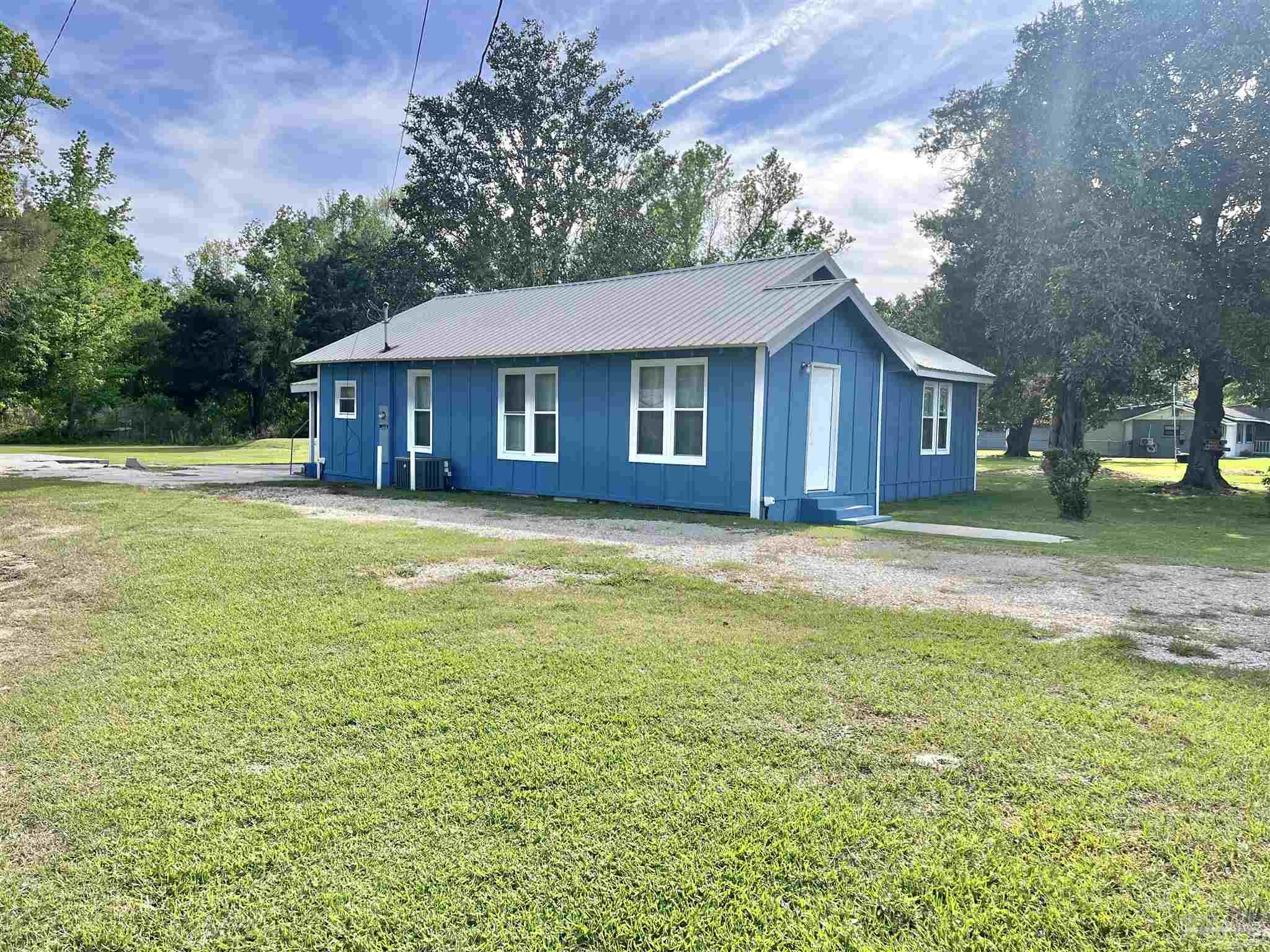 102 W Avenue Atmore, AL 36502 - Photo 4 of 25 a view of a house with a yard