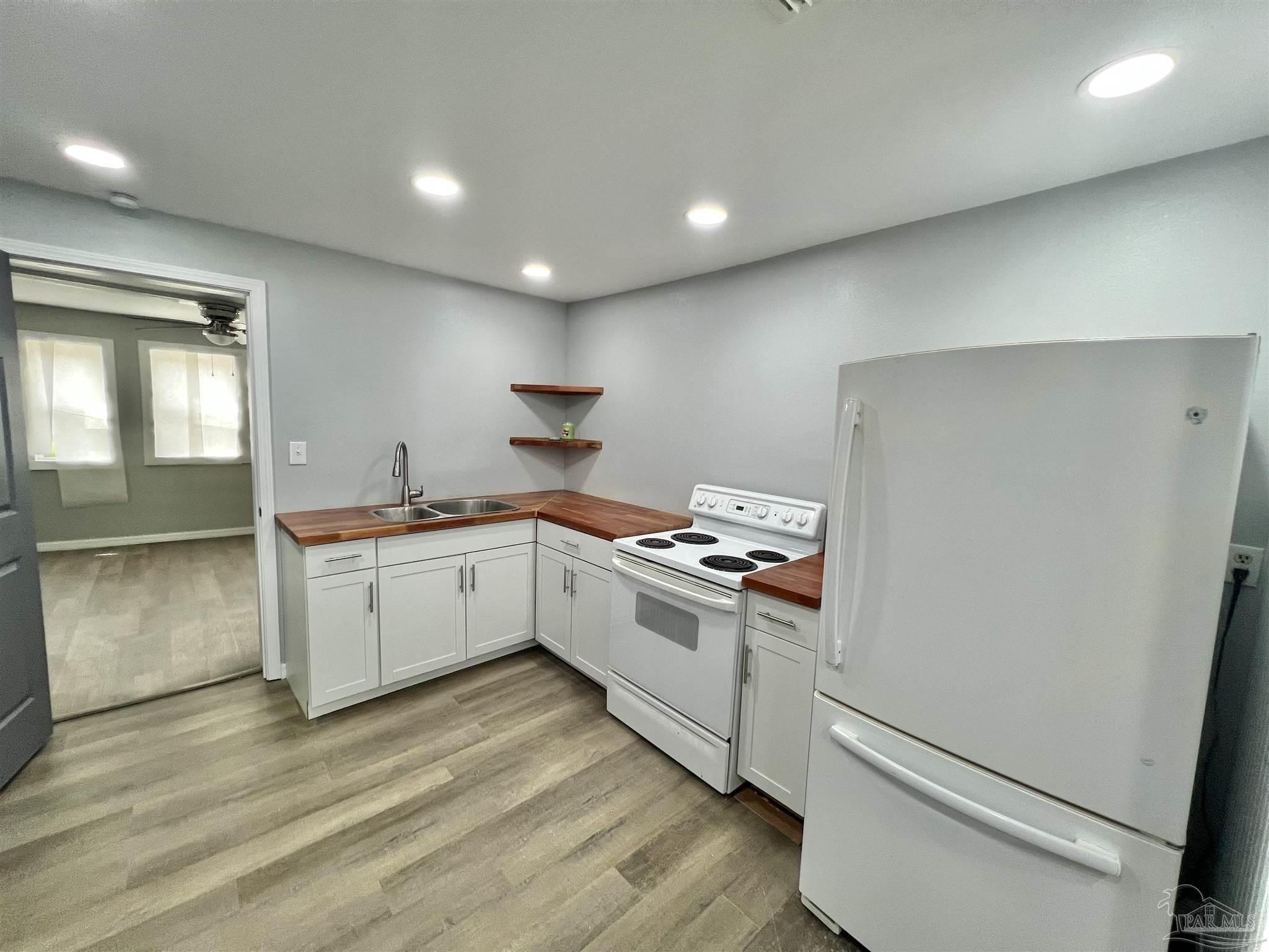 102 W Avenue Atmore, AL 36502 - Photo 8 of 25 a kitchen with a sink and wooden floor