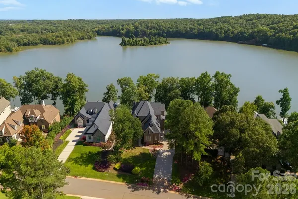 an aerial view of lake and residential houses with outdoor space