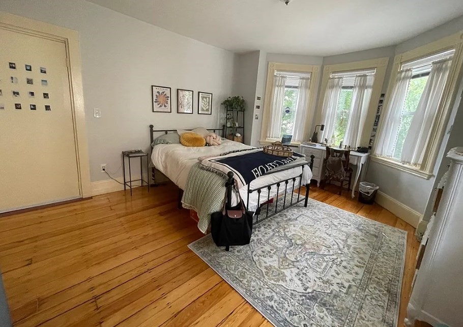 787 Boylston Street, Unit 3 Brookline, MA 02467 - Photo 6 of 11 a bed sitting in a bedroom next to a window with a flat screen tv