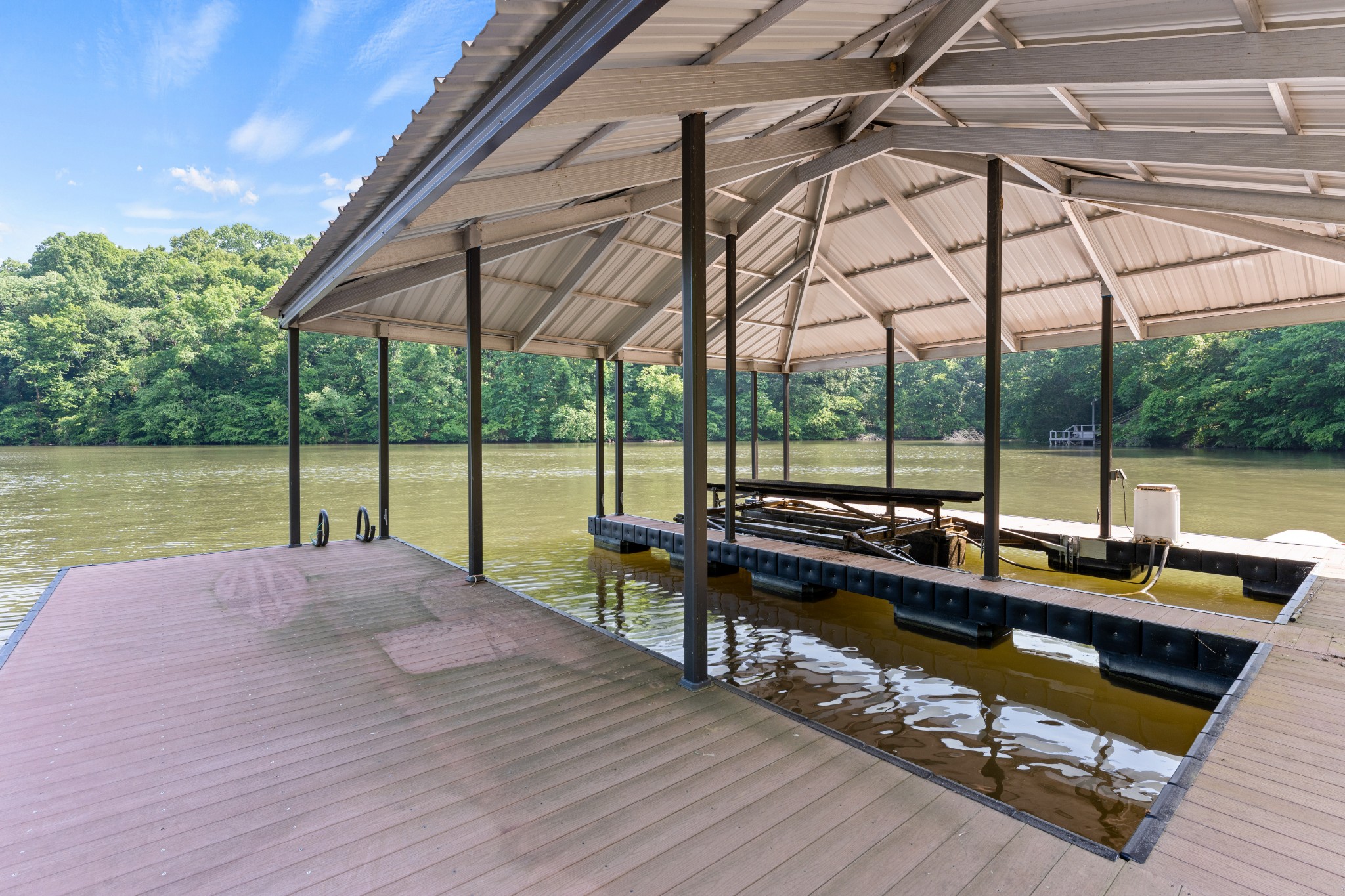 236 Beech Hill Drive Winchester, TN 37398 - Photo 31 of 70 a view of a roof deck with a table and chairs under an umbrella