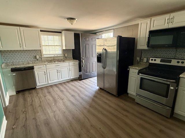5715 Harding Drive Mableton, GA 30126 - Photo 12 of 13 a kitchen with granite countertop a refrigerator and a stove top oven