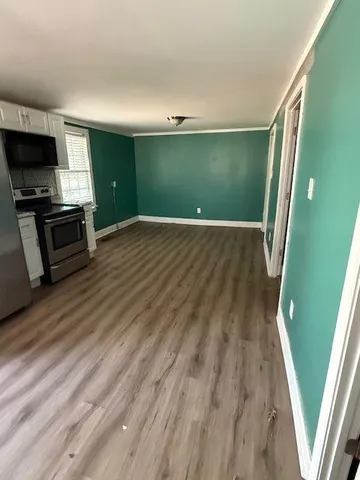 wooden floor in an empty room with a fireplace