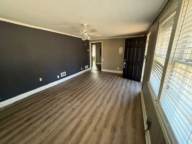 wooden floor in an empty room with a window