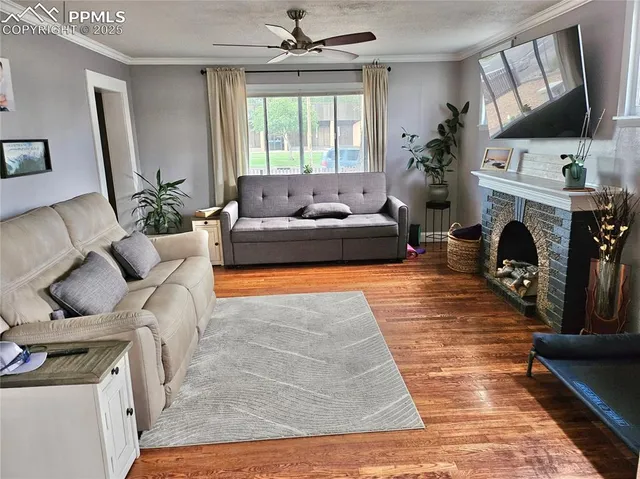 a living room with furniture a fireplace and a flat screen tv