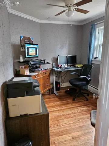 a work room with furniture and a flat screen tv