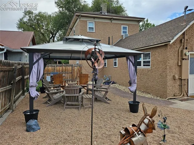 a view of house with yard outdoor seating area