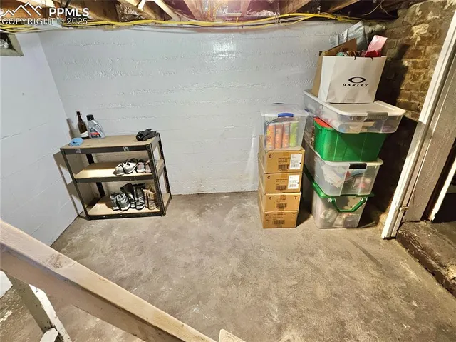 a view of a room with bed and wooden floor