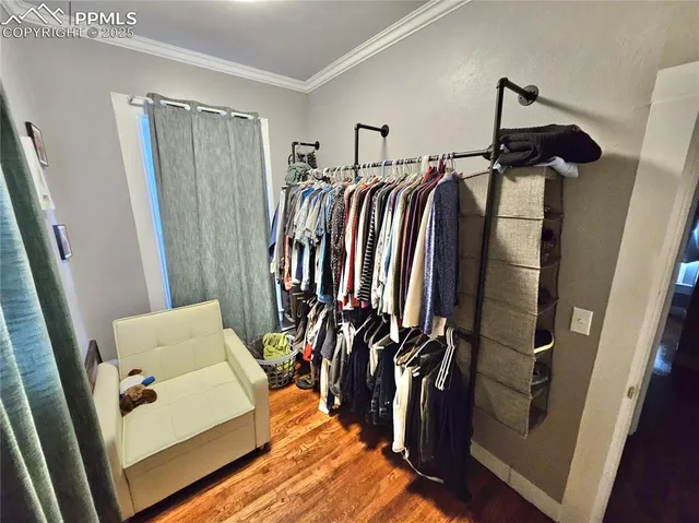 a view of walk in closet with clothes and shoes
