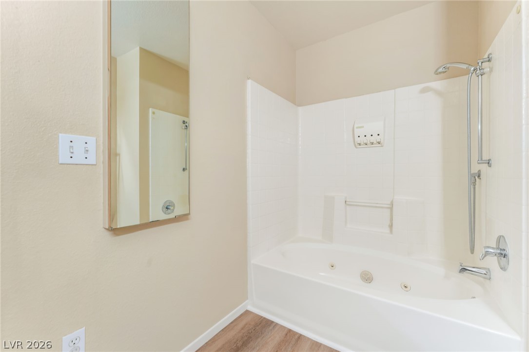 8070 West Russell Road, Unit 1054 Las Vegas, NV 89113 - Photo 14 of 22 Relax in the soothing jetted tub, a highlight of this inviting bathroom retreat.