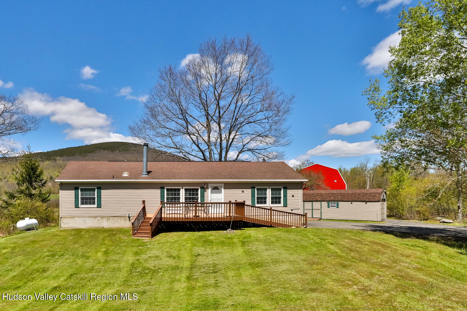 a front view of house with yard and garage