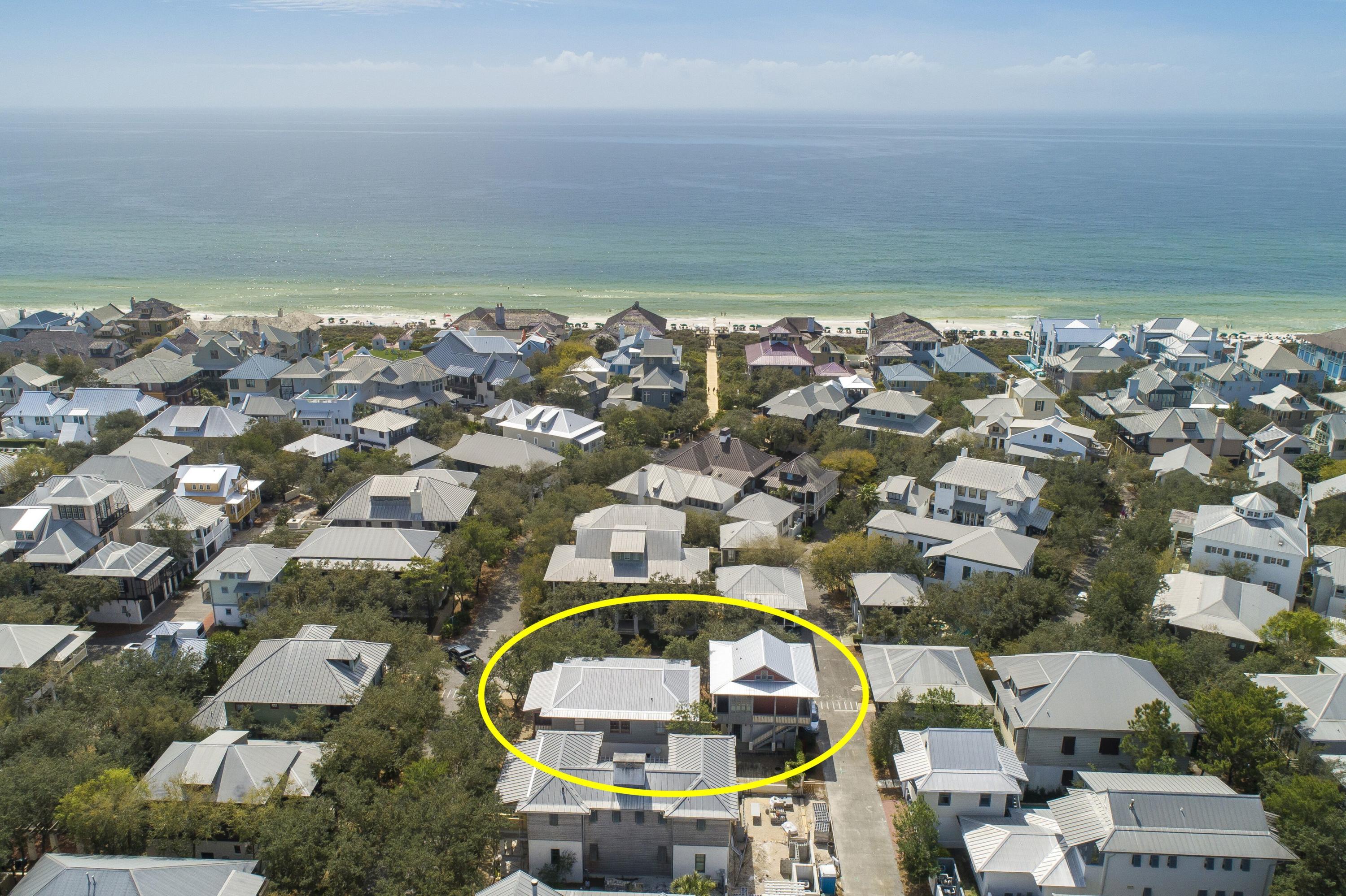 an aerial view of a house with a swimming pool and outdoor seating