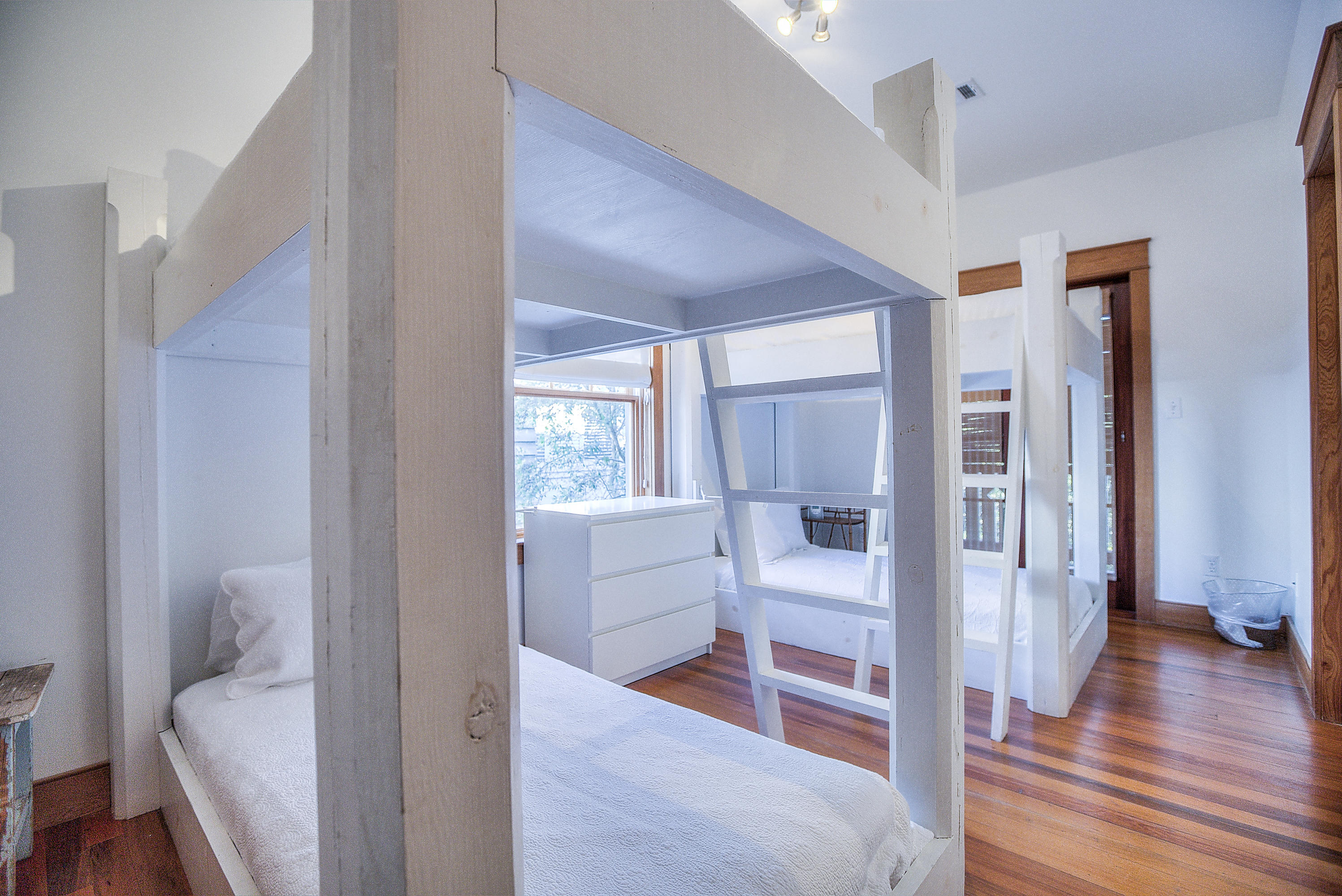 61 Round Road Ln Inlet Beach Inlet Beach, FL 32461 - Photo 21 of 38 a view of a bedroom with wooden floor and windows