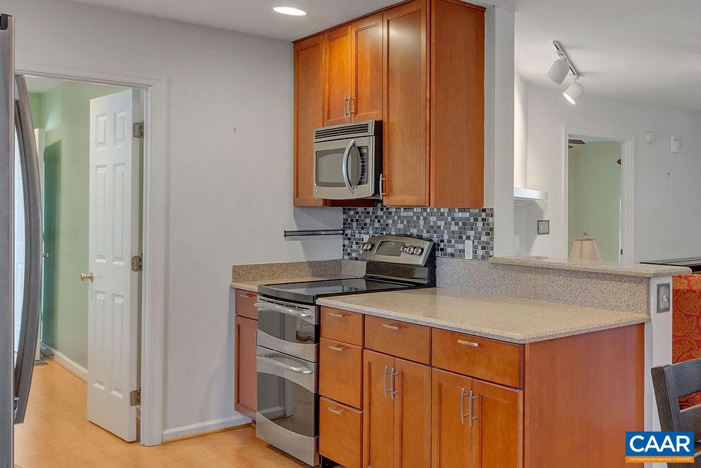 14 Powhatan Road Palmyra, VA 22963 - Photo 12 of 38 a kitchen with stainless steel appliances granite countertop a sink and a refrigerator