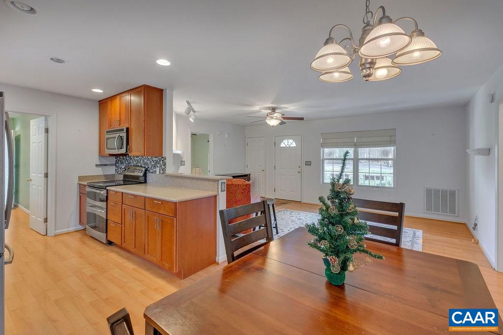 14 Powhatan Road Palmyra, VA 22963 - Photo 8 of 38 a large kitchen with kitchen island granite countertop wooden floor stainless steel appliances and a fireplace