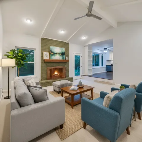 a living room with furniture and a fireplace