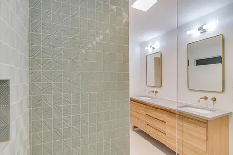 a bathroom with a double vanity sink mirror and