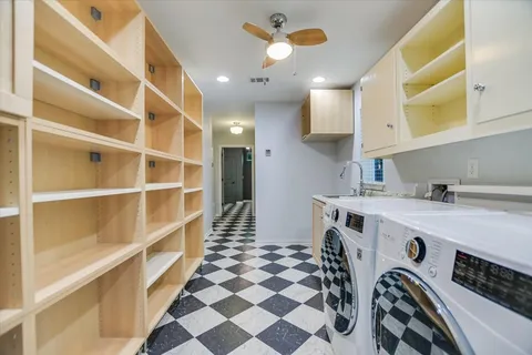 a view of a kitchen with a sink and a refrigerator