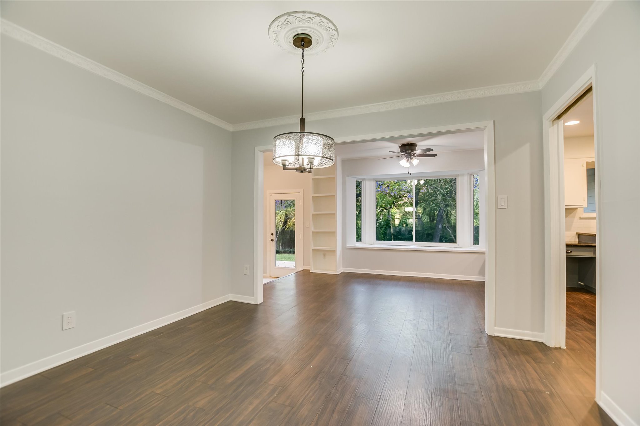 3921 Greystone Drive Austin, TX 78731 - Photo 5 of 30 a view of an empty room with wooden floor and a window