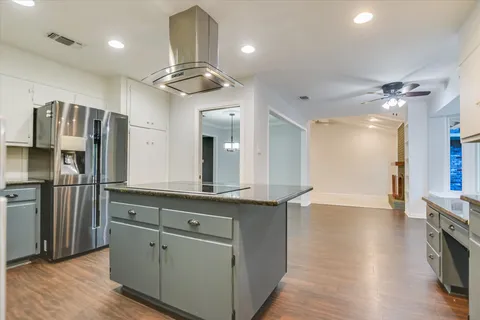 a kitchen with stainless steel appliances granite countertop a refrigerator a sink and a stove