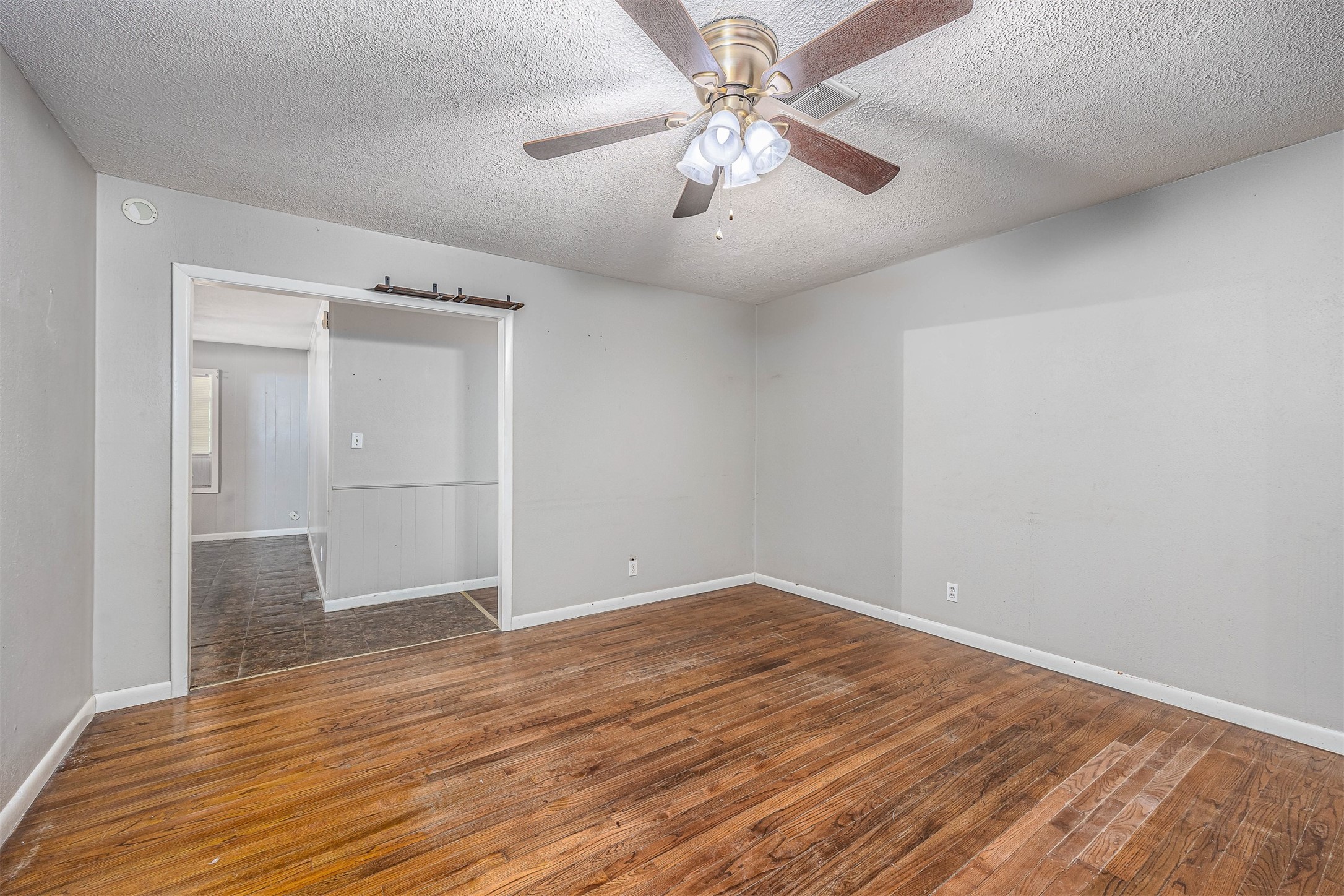 502 Massey Tompkins Road Baytown, TX 77521 - Photo 6 of 32 an empty room with wooden floor and windows