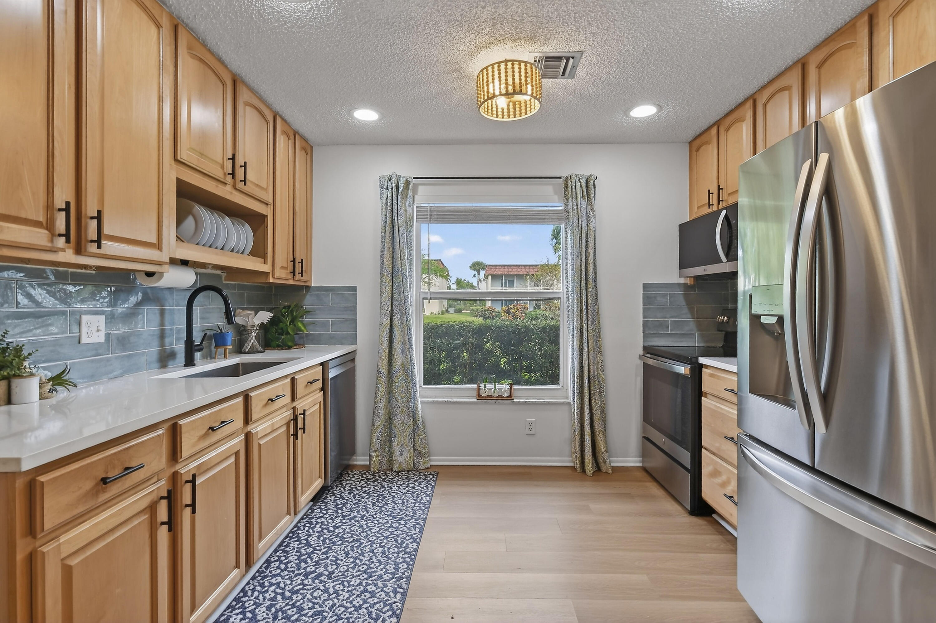 717 Highway 1, Unit 912 Jupiter, FL 33477 - Photo 11 of 45 a kitchen with stainless steel appliances granite countertop a refrigerator and a sink