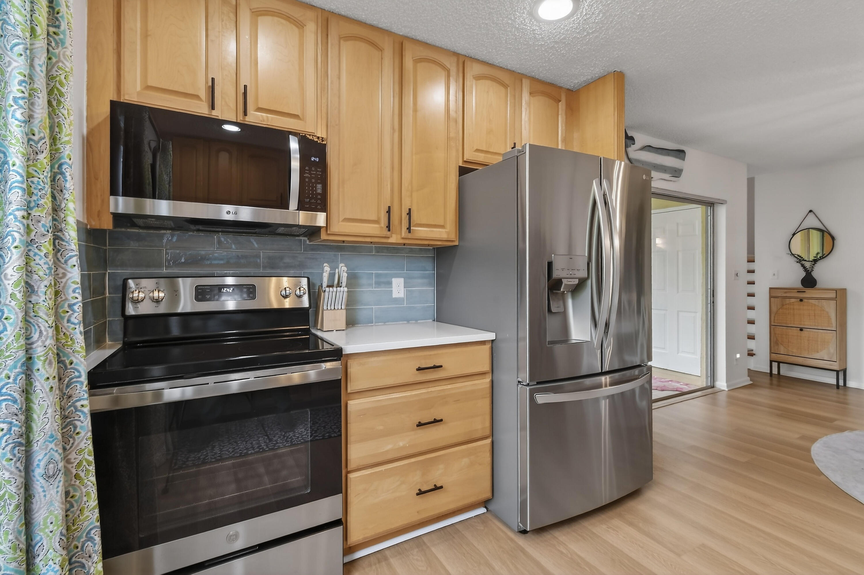 717 Highway 1, Unit 912 Jupiter, FL 33477 - Photo 15 of 45 a kitchen with granite countertop wooden cabinets and stainless steel appliances