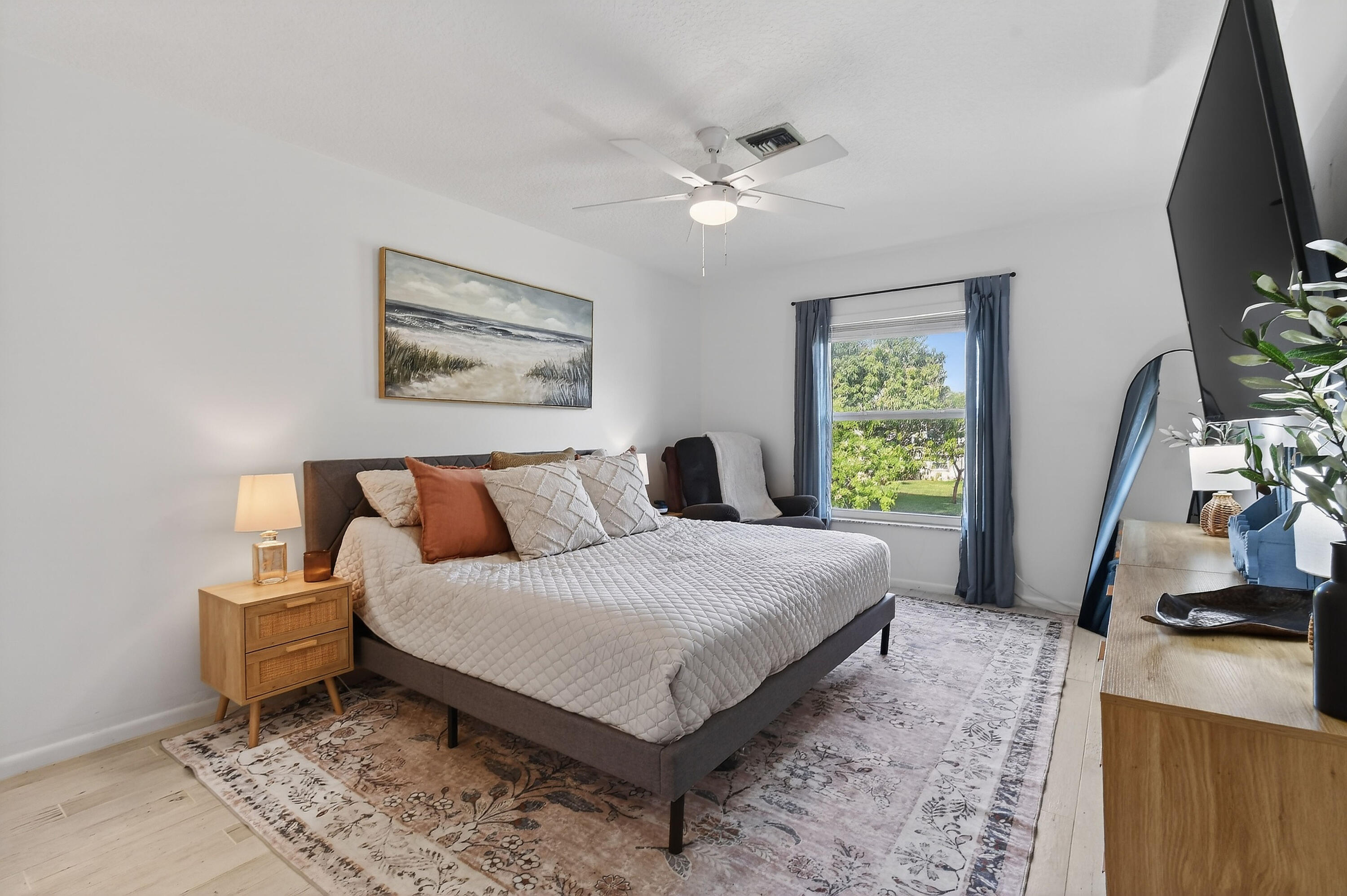 717 Highway 1, Unit 912 Jupiter, FL 33477 - Photo 20 of 45 a bedroom with a bed a couch and a flat tv screen on a table