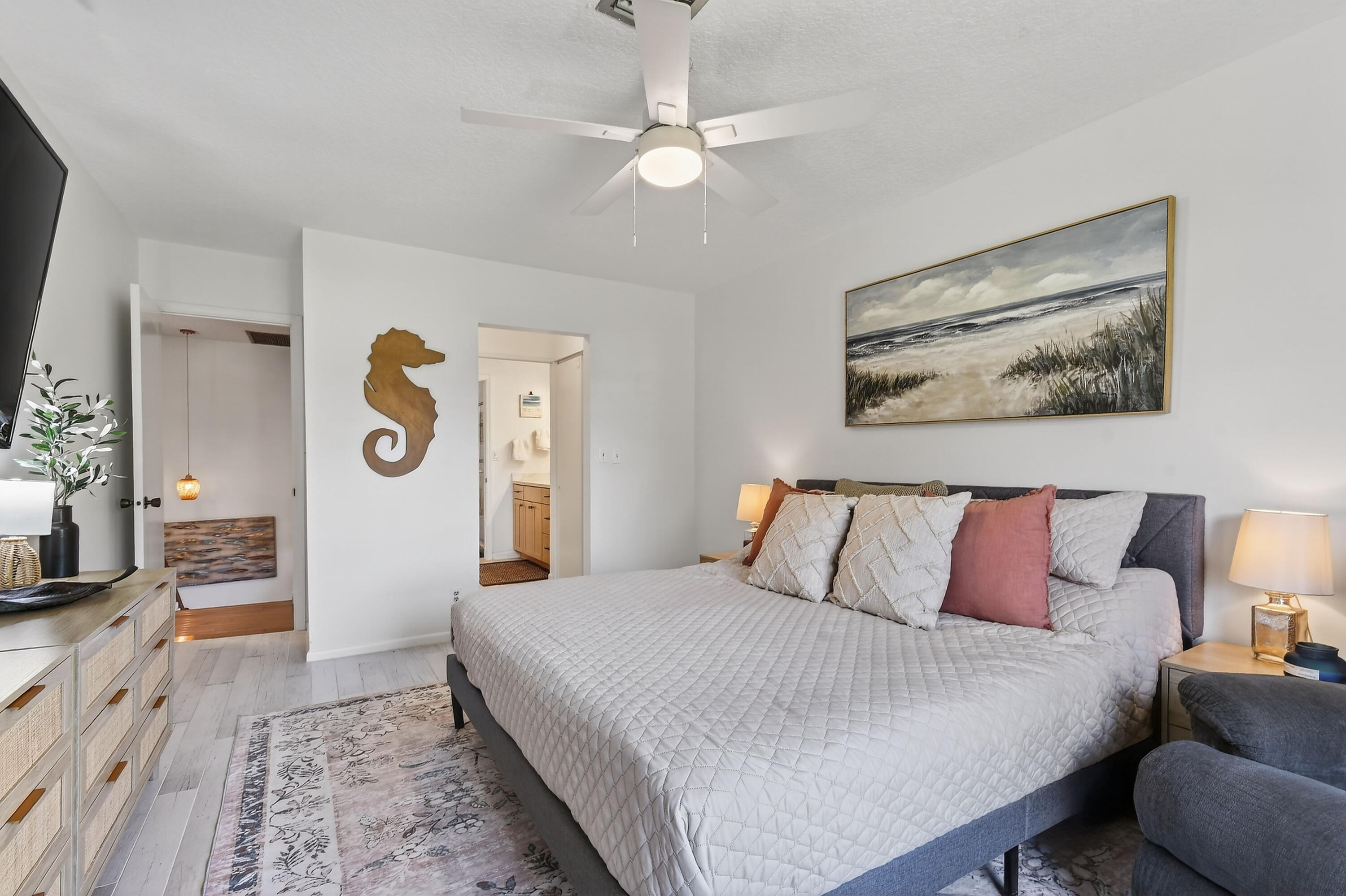717 Highway 1, Unit 912 Jupiter, FL 33477 - Photo 22 of 45 a bedroom with a large bed and a chandelier