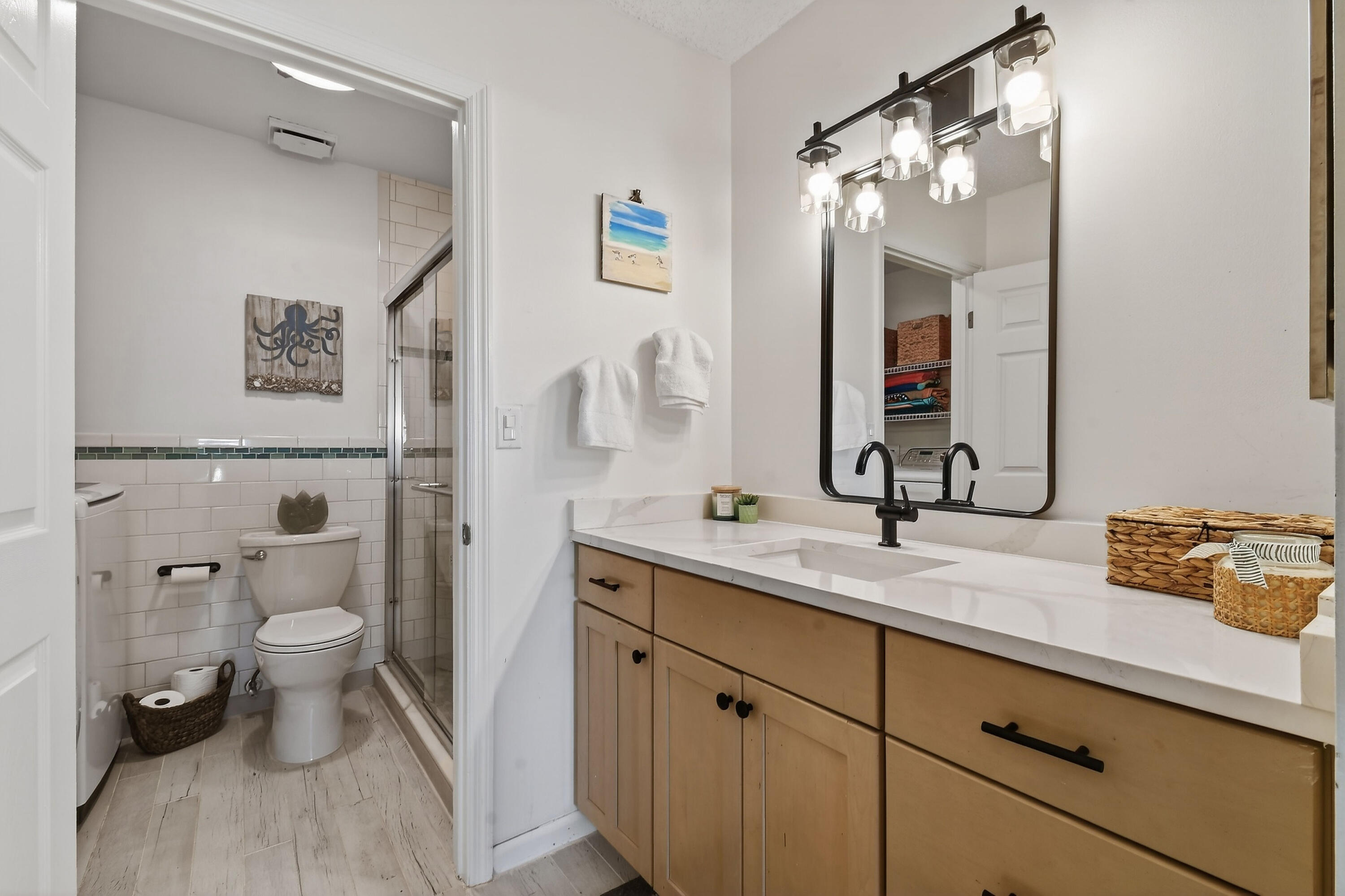 717 Highway 1, Unit 912 Jupiter, FL 33477 - Photo 23 of 45 a bathroom with a toilet a sink and mirror
