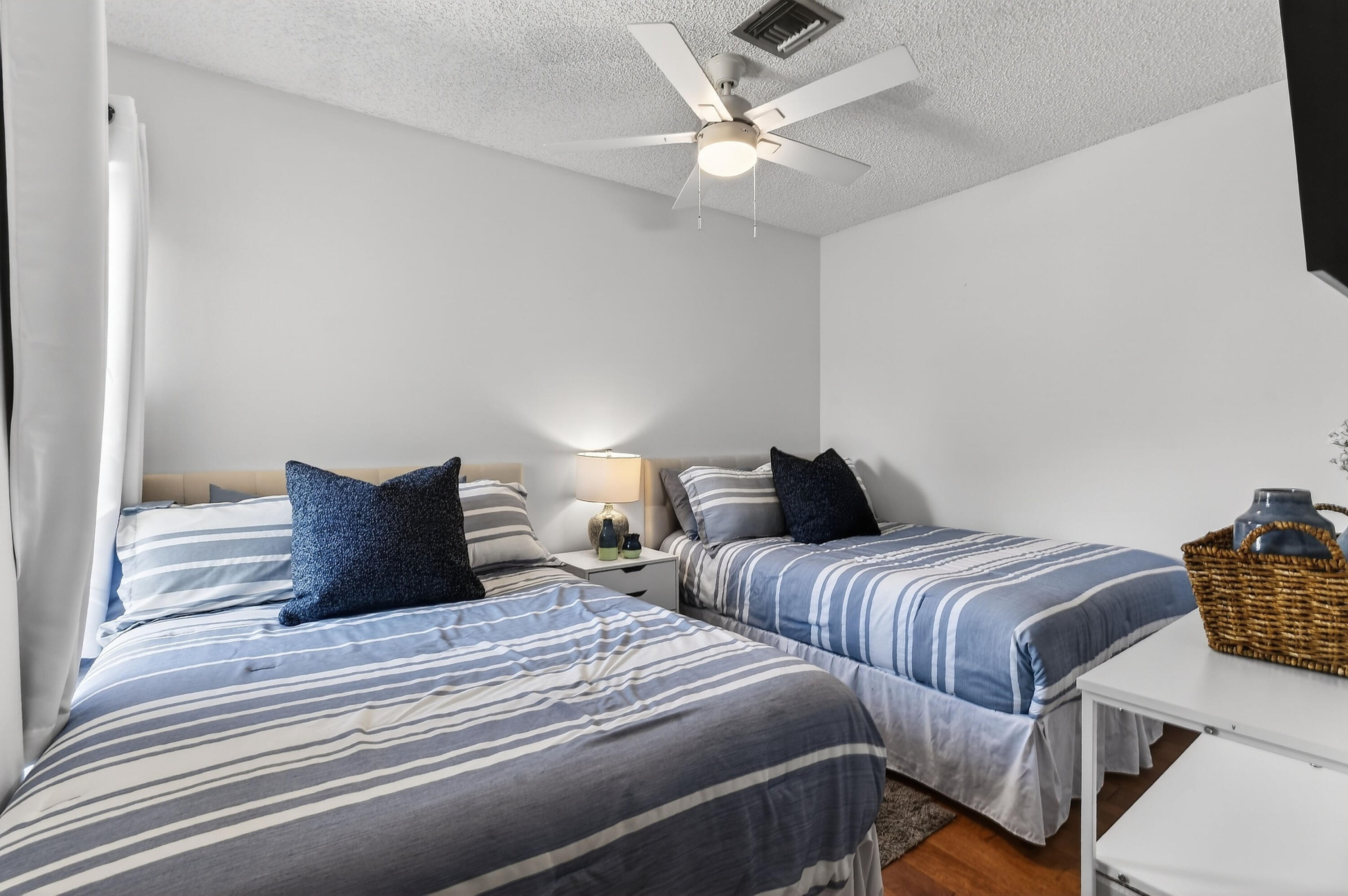 717 Highway 1, Unit 912 Jupiter, FL 33477 - Photo 30 of 45 a bedroom with two beds and a chandelier