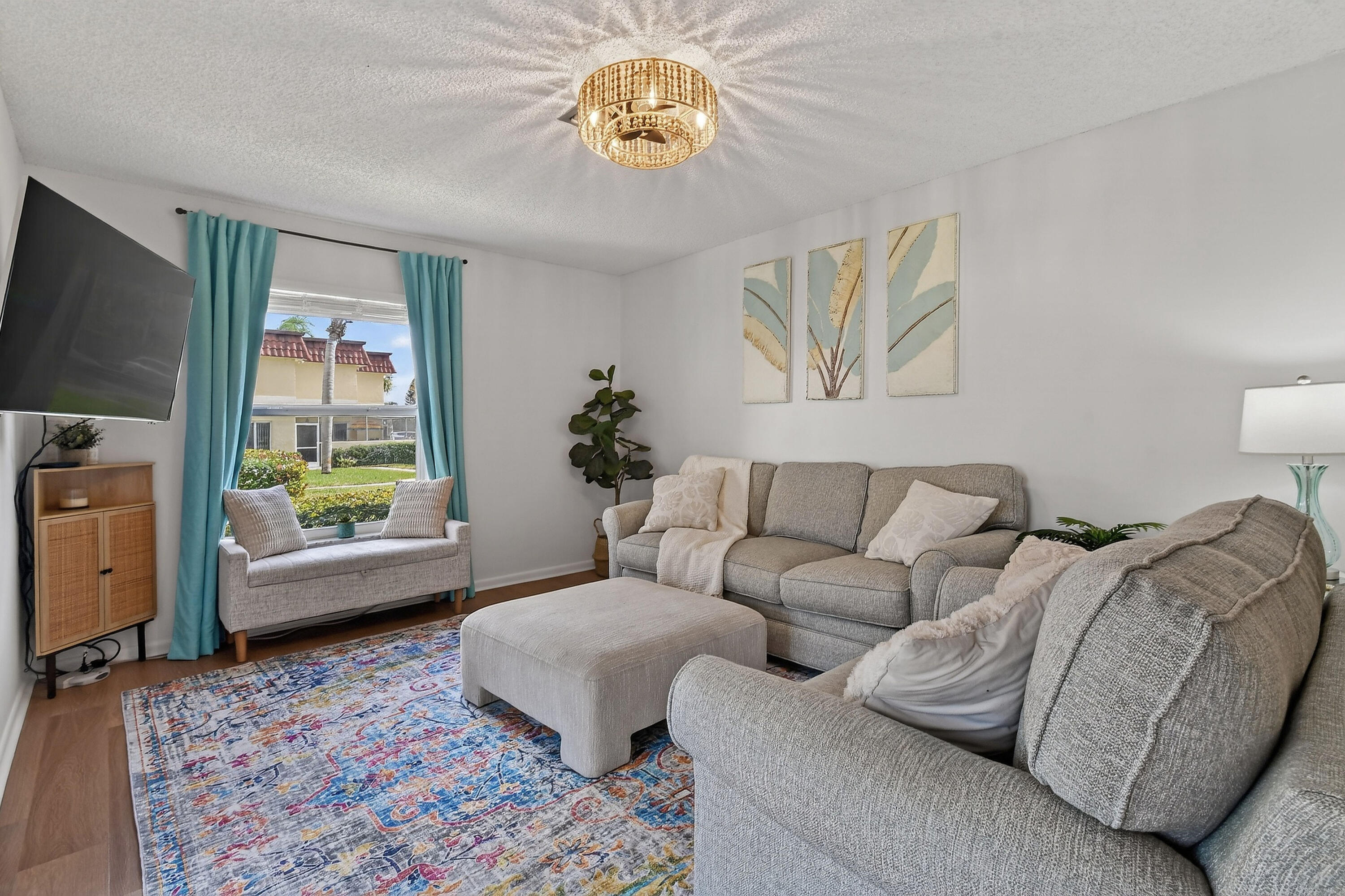 717 Highway 1, Unit 912 Jupiter, FL 33477 - Photo 4 of 45 a living room with furniture and a flat screen tv