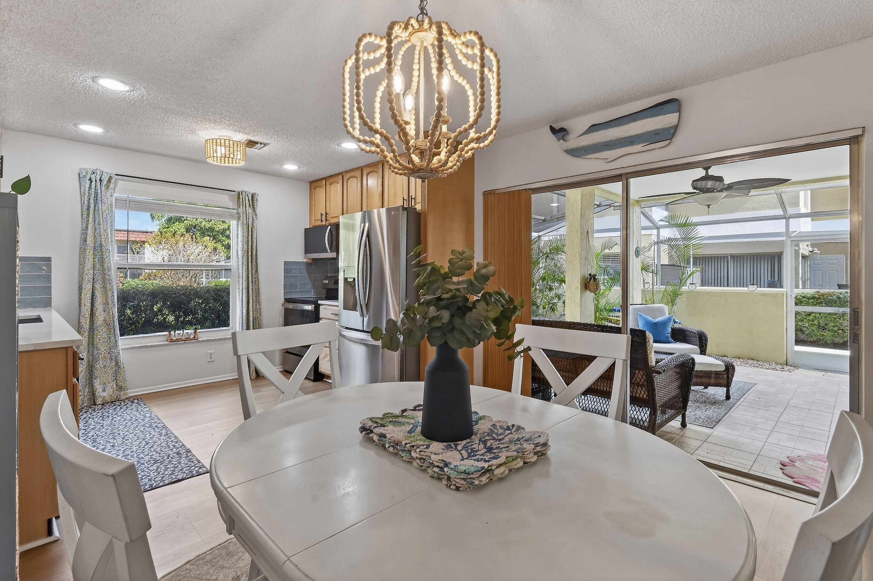 717 Highway 1, Unit 912 Jupiter, FL 33477 - Photo 9 of 45 a view of a dining room with furniture a chandelier and wooden floor