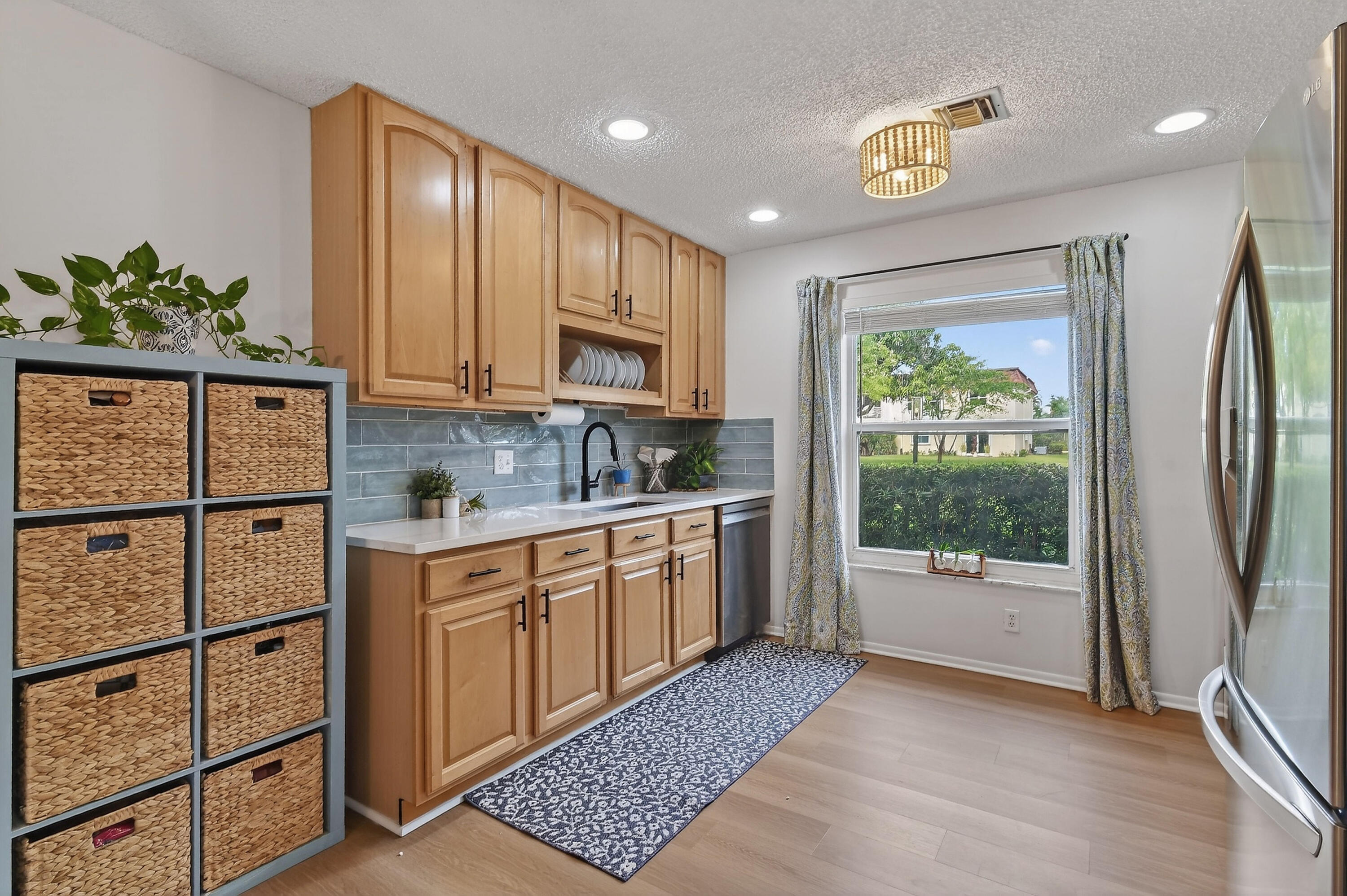717 Highway 1, Unit 912 Jupiter, FL 33477 - Photo 10 of 45 a kitchen with stainless steel appliances granite countertop a refrigerator sink and cabinets