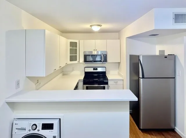 a kitchen with a refrigerator and a stove
