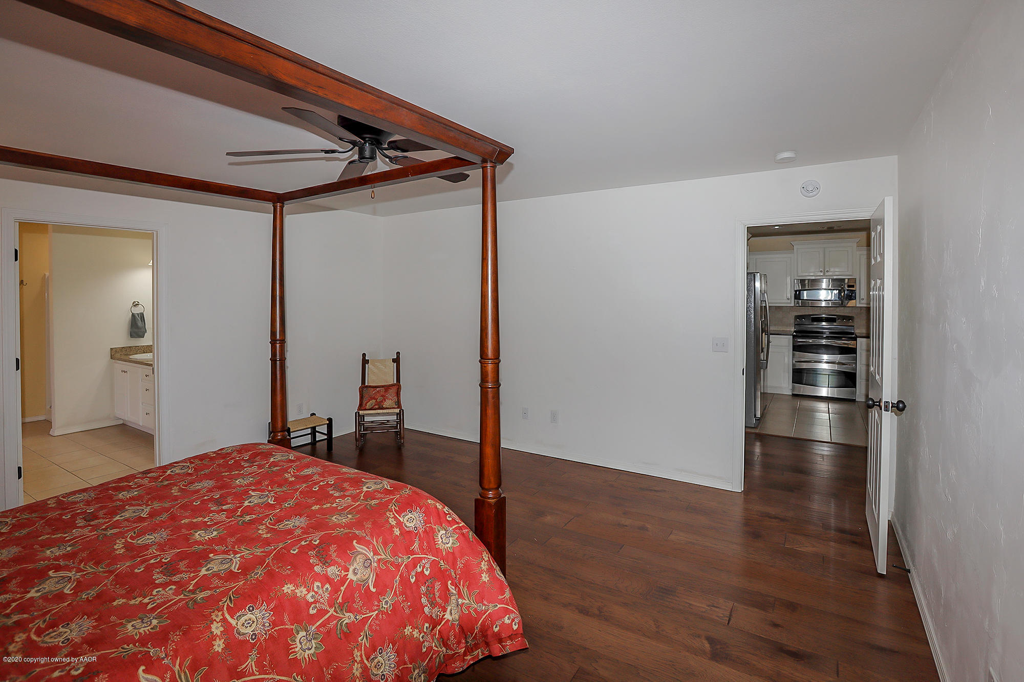 7003 Nick Street Amarillo, TX 79119 - Photo 11 of 34 a bedroom with a bed and wooden floor