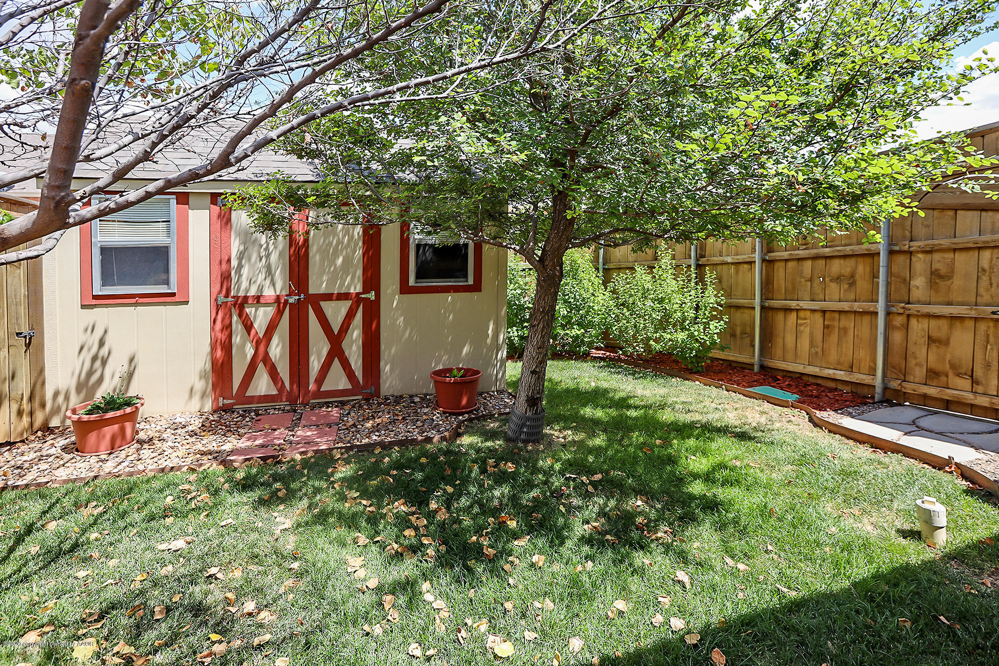 7003 Nick Street Amarillo, TX 79119 - Photo 31 of 34 a view of a backyard with plants and tree