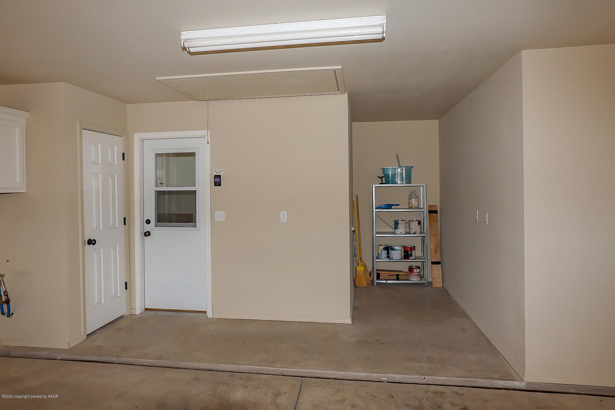 7003 Nick Street Amarillo, TX 79119 - Photo 32 of 34 a view of a hallway with wooden shelves