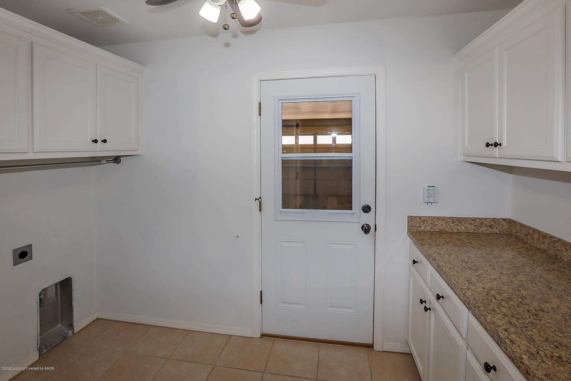 7003 Nick Street Amarillo, TX 79119 - Photo 34 of 34 a kitchen with granite countertop white cabinets and white appliances