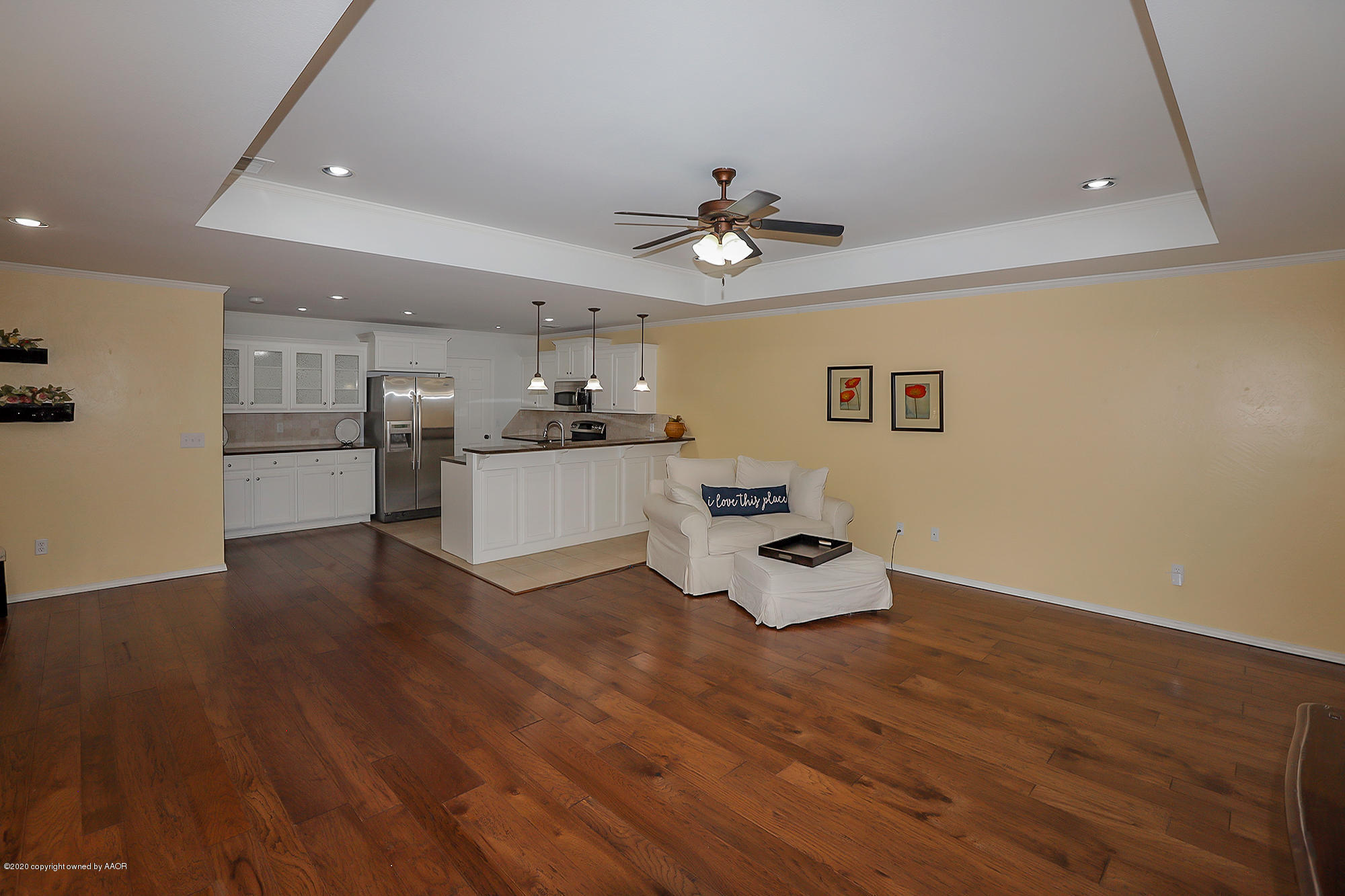 7003 Nick Street Amarillo, TX 79119 - Photo 6 of 34 a kitchen with stainless steel appliances wooden floor and a refrigerator