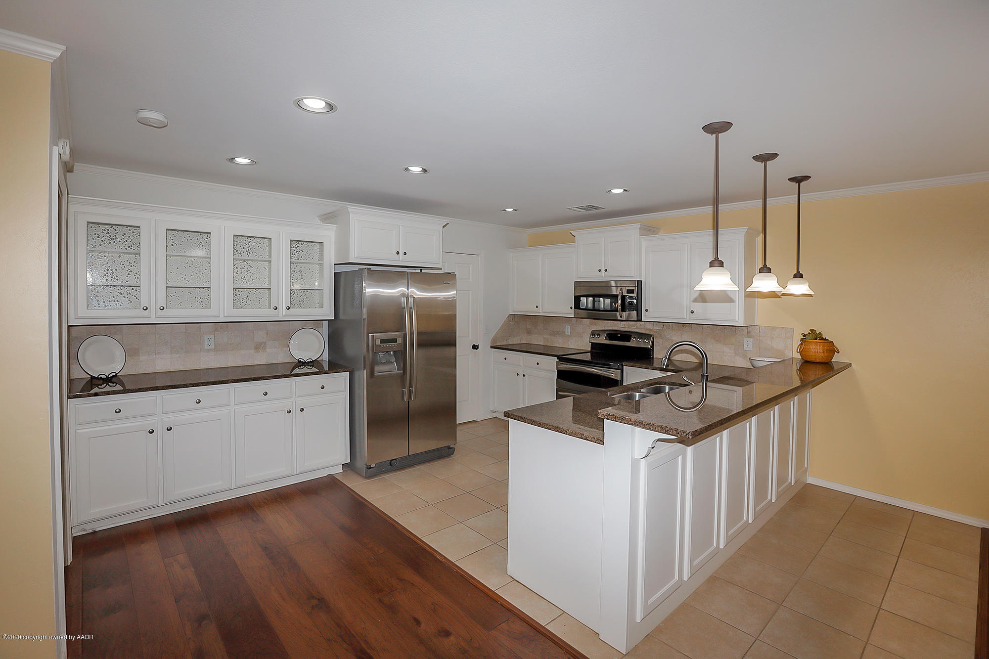7003 Nick Street Amarillo, TX 79119 - Photo 9 of 34 a kitchen with stainless steel appliances granite countertop a sink stove and refrigerator