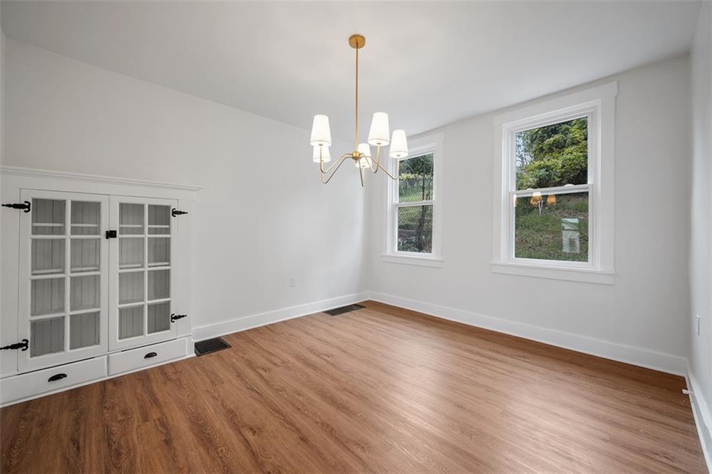 230 Linnview Avenue Pittsburgh, PA 15210 - Photo 12 of 32 a view of an empty room with wooden floor and a window