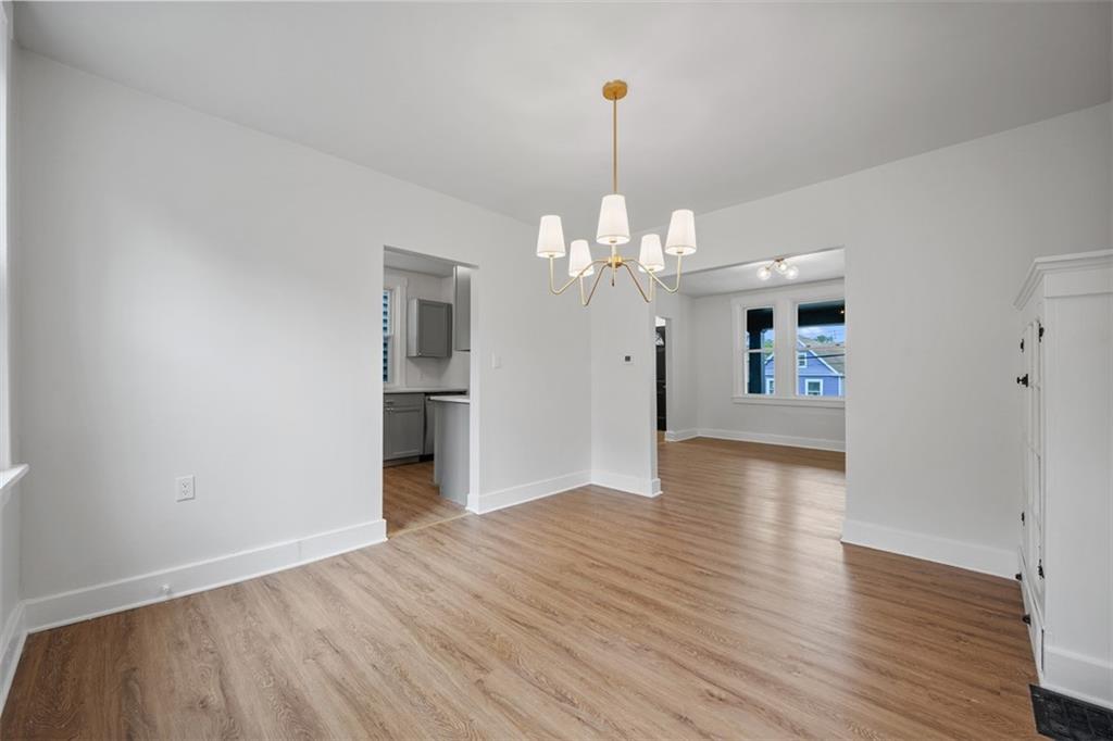 230 Linnview Avenue Pittsburgh, PA 15210 - Photo 14 of 32 a view of a livingroom with a chandelier fan and wooden floor