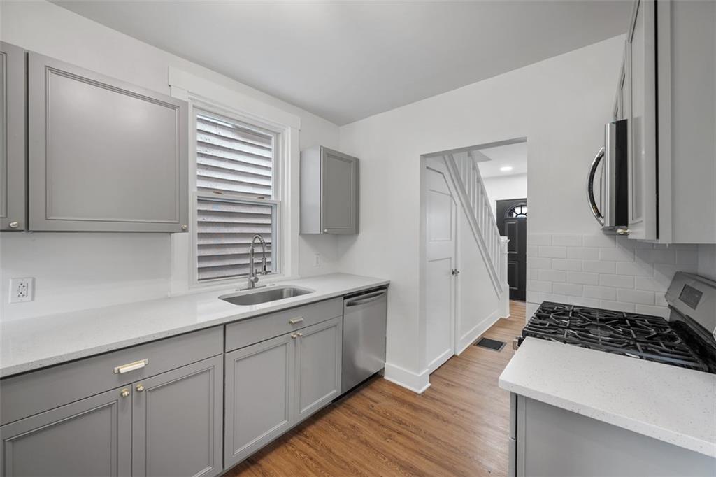 230 Linnview Avenue Pittsburgh, PA 15210 - Photo 15 of 32 a kitchen with a sink and a stove top oven