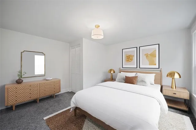 a bedroom with bed and window