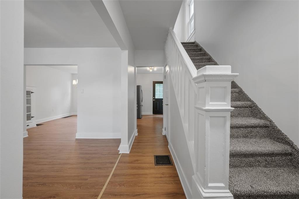 230 Linnview Avenue Pittsburgh, PA 15210 - Photo 7 of 32 a view of a hallway with wooden floor and staircase