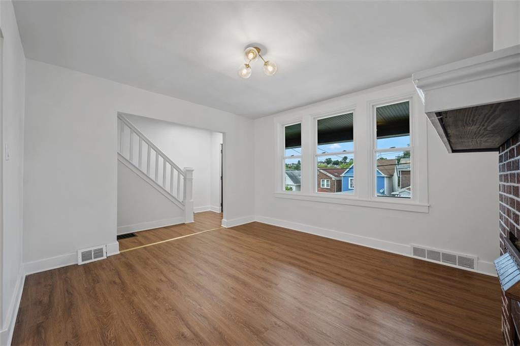 230 Linnview Avenue Pittsburgh, PA 15210 - Photo 10 of 32 a view of an empty room with window and wooden floor
