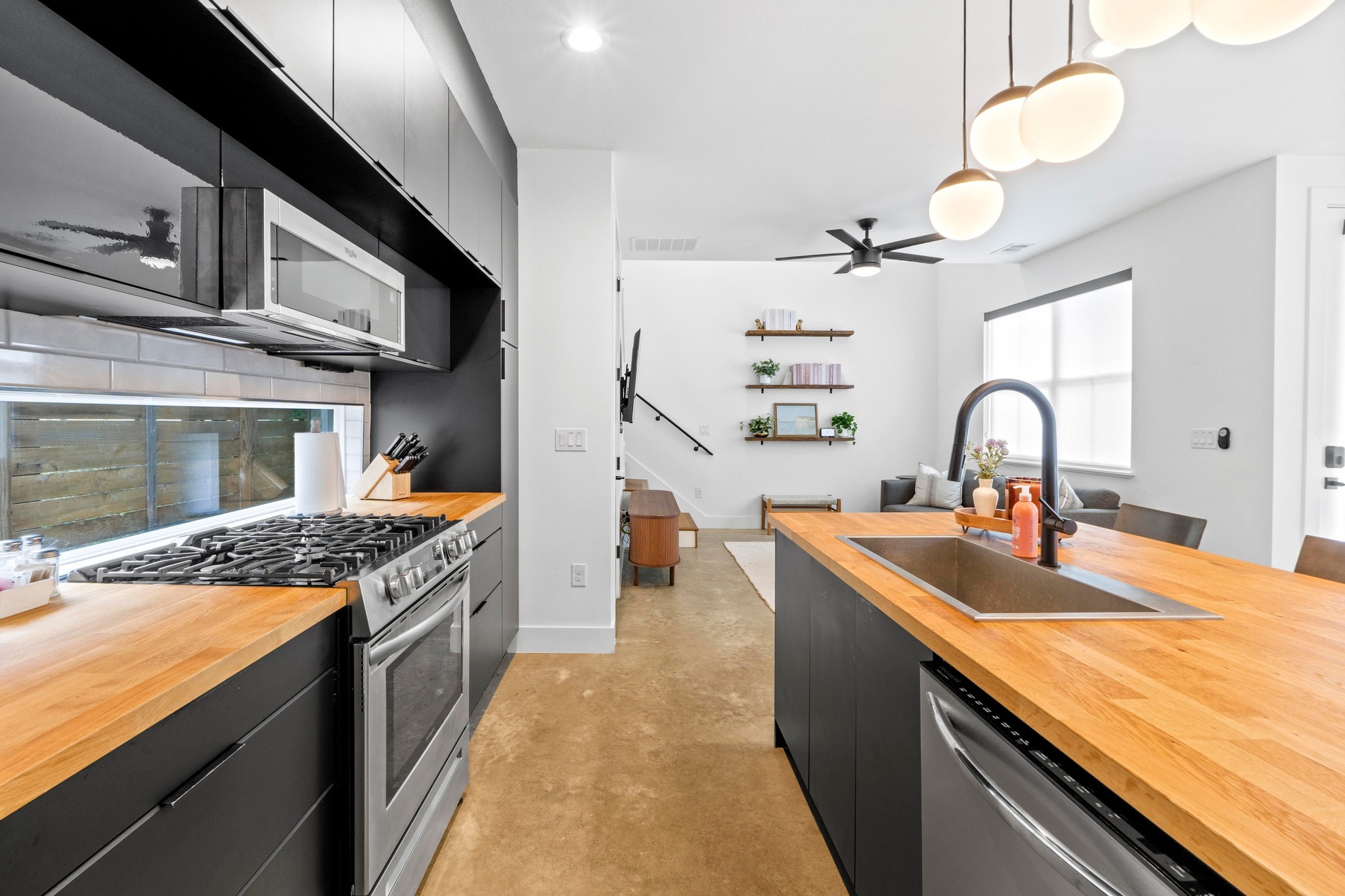 1706 Perez Street, Unit 2 Austin, TX 78721 - Photo 11 of 29 A sleek, contemporary kitchen boasts stainless steel appliances and natural wood countertops.